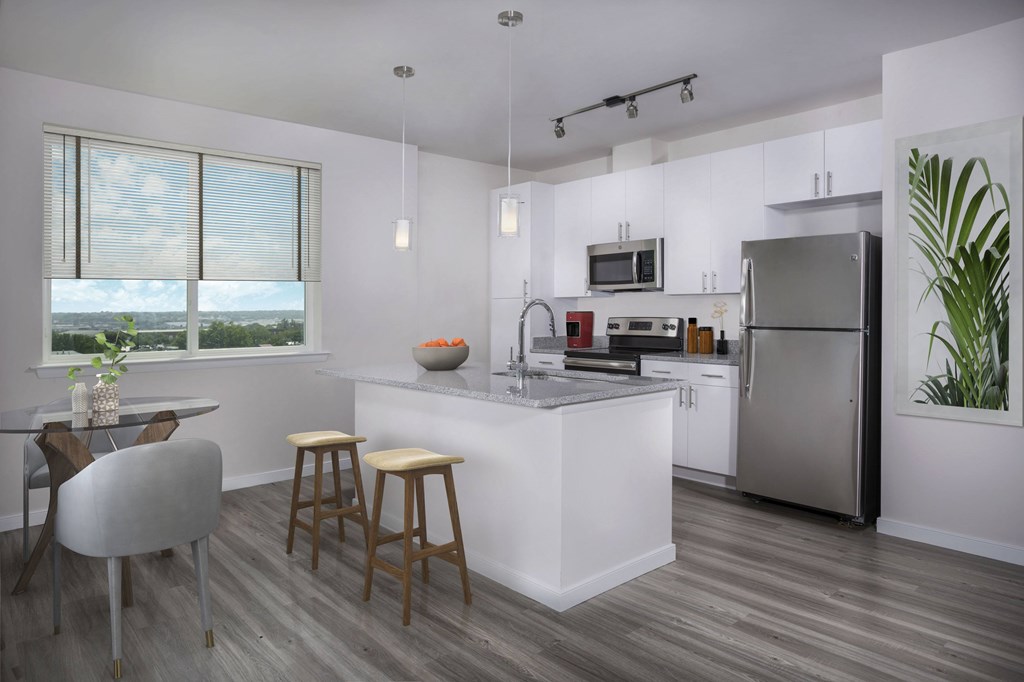 A modern kitchen with a dining table and chairs.
