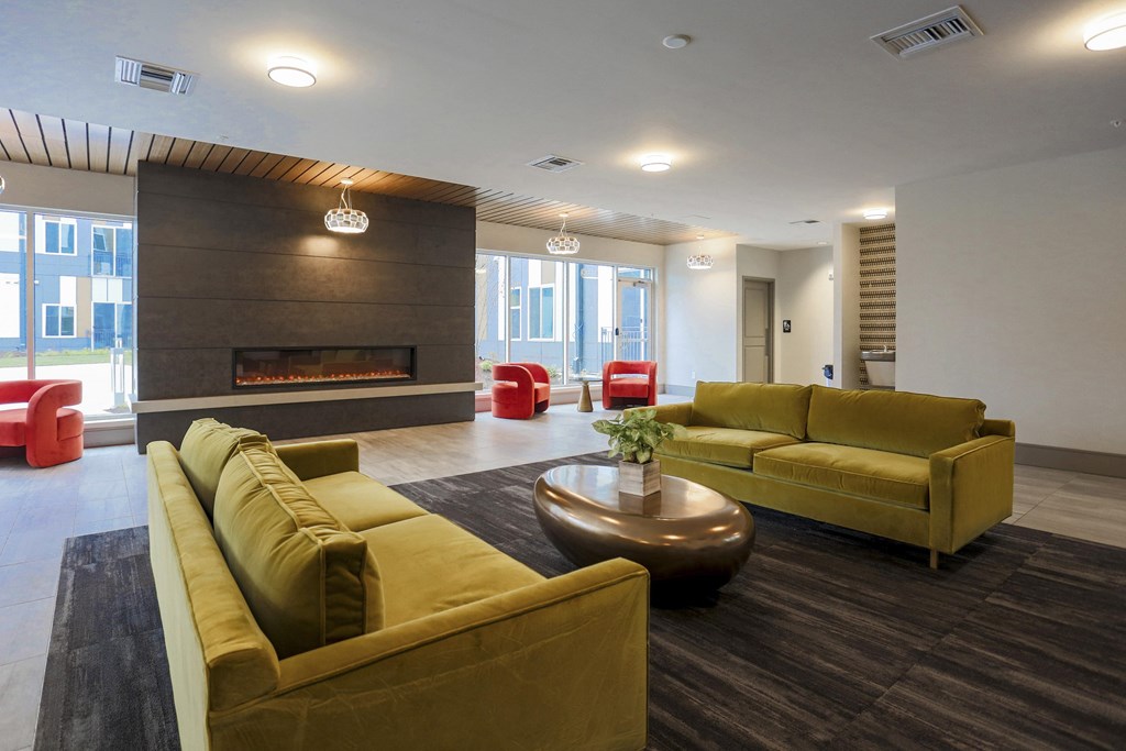 A living room with a fireplace and a yellow couch.