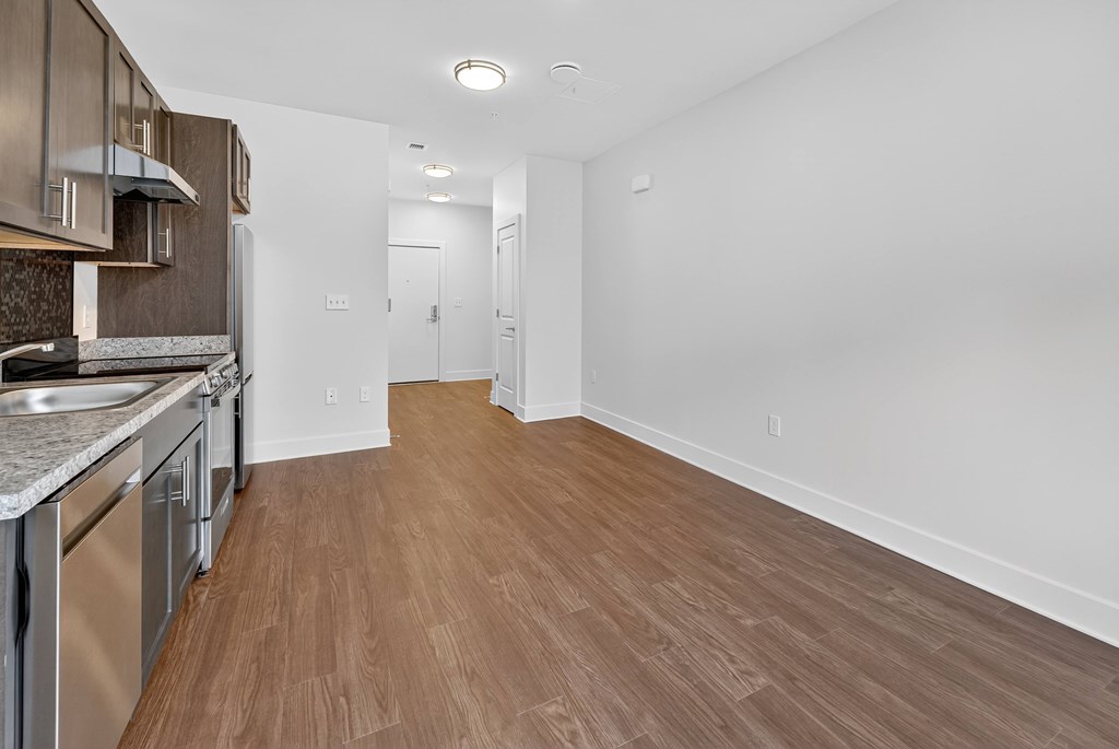 A kitchen with wooden floors and stainless steel appliances.