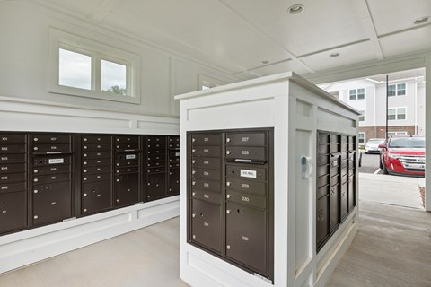 A row of mailboxes are lined up on the sidewalk.
