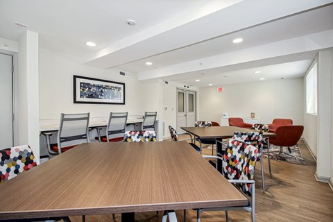 A conference room with a long table surrounded by chairs.