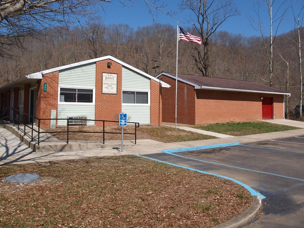 a brick school building with an flag in front of it