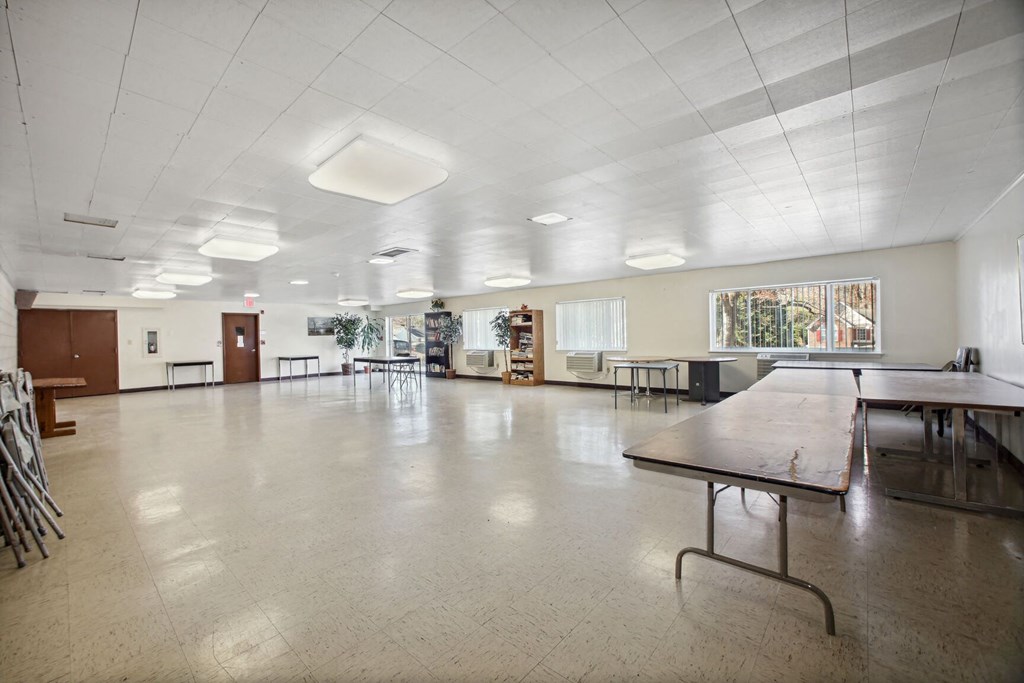 a large room with a table in the middle of it