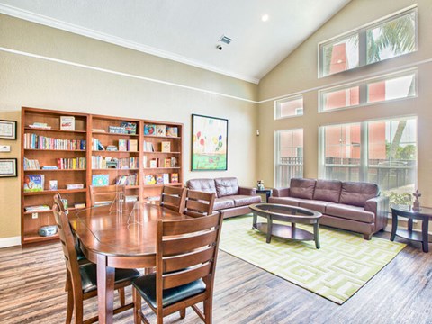 A living room with a dining table and chairs.