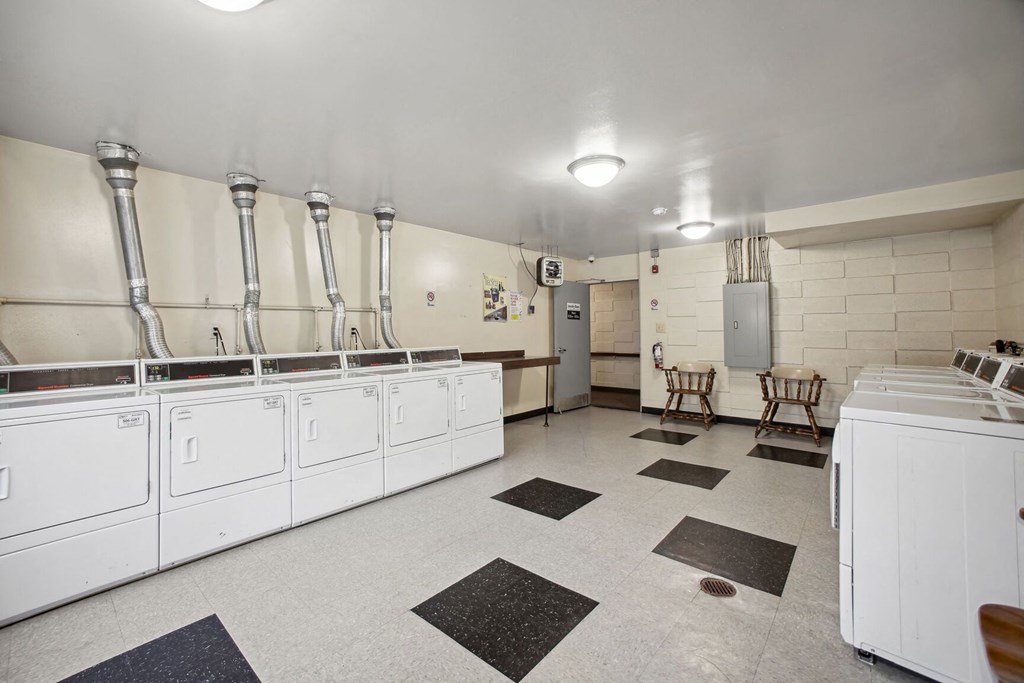 a large kitchen with white appliances and counters and white walls