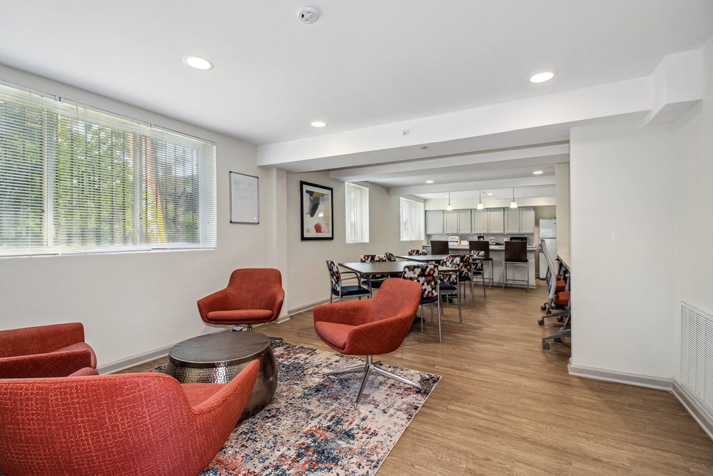 a living room with couches and chairs and a dining table