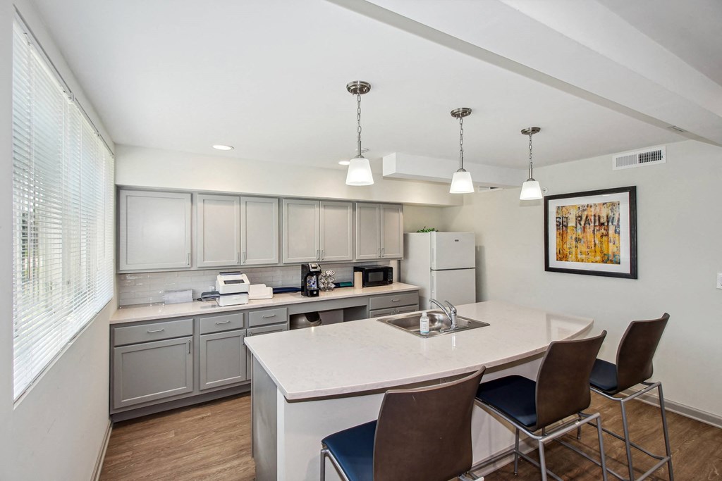 a kitchen with a large island and a white counter top