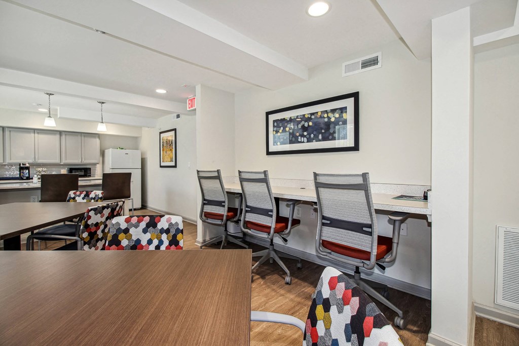 a conference room with a table and chairs and a kitchen