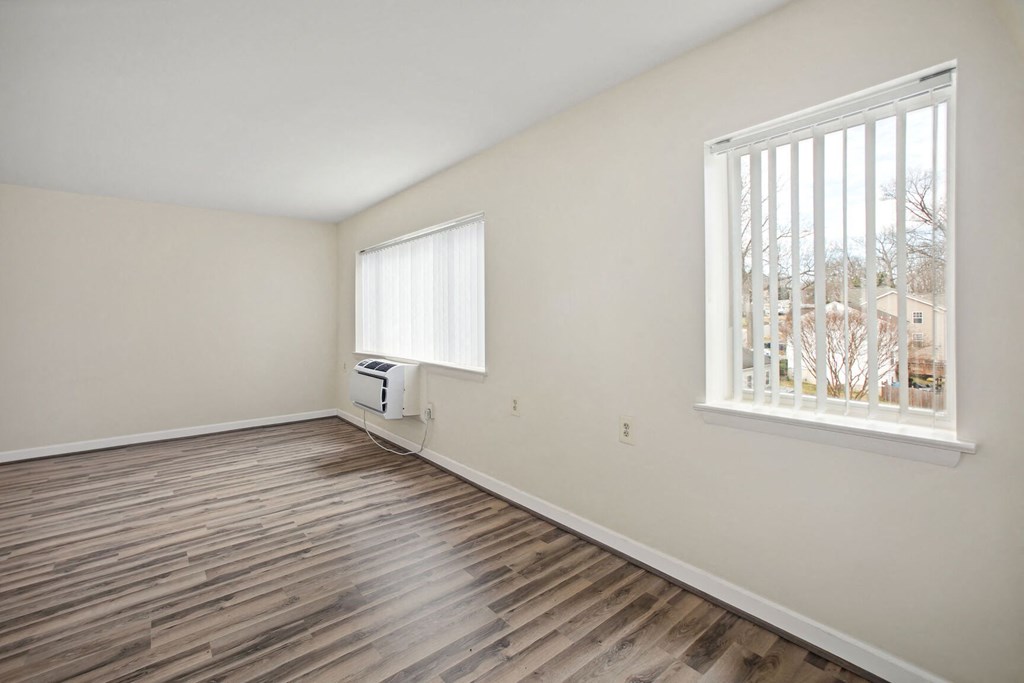 a living room with hardwood floors and a large window