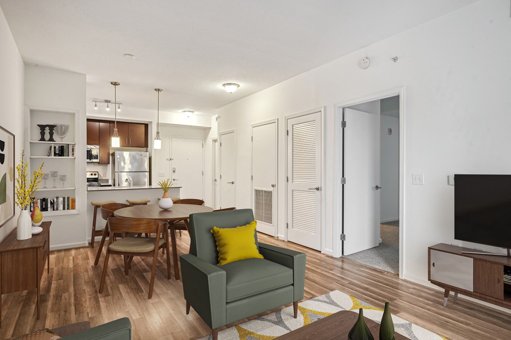 a living room and dining room with a table and chairs