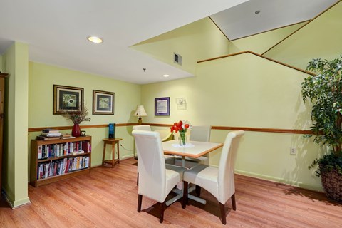 a dining room with a table and chairs and a book shelf