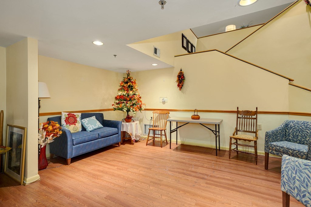 a living room with a couch and a table and a christmas tree