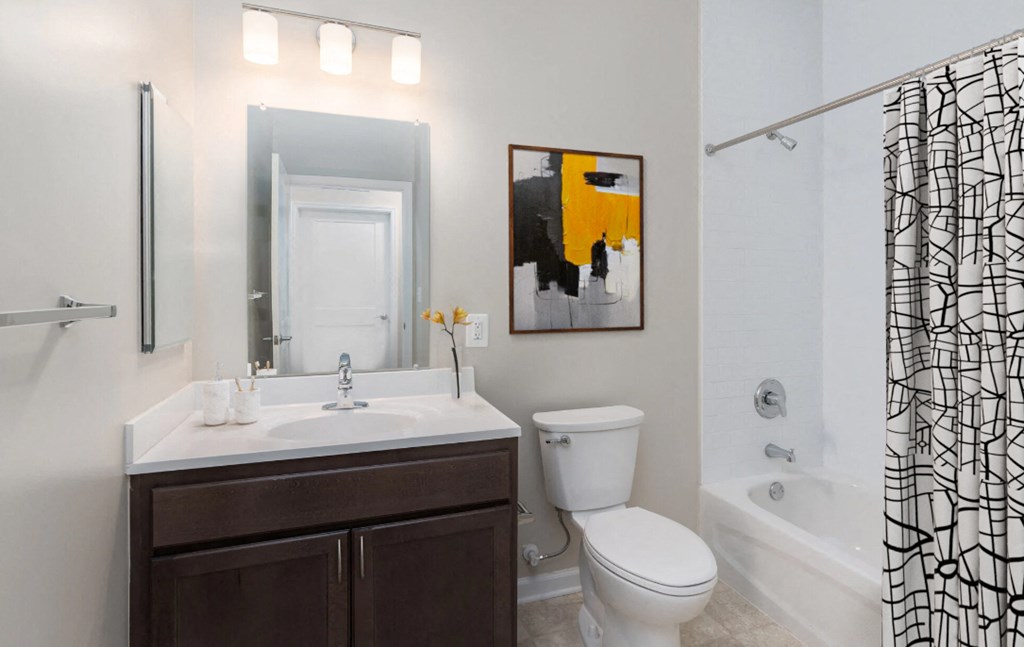 a bathroom with a toilet sink and shower and a mirror