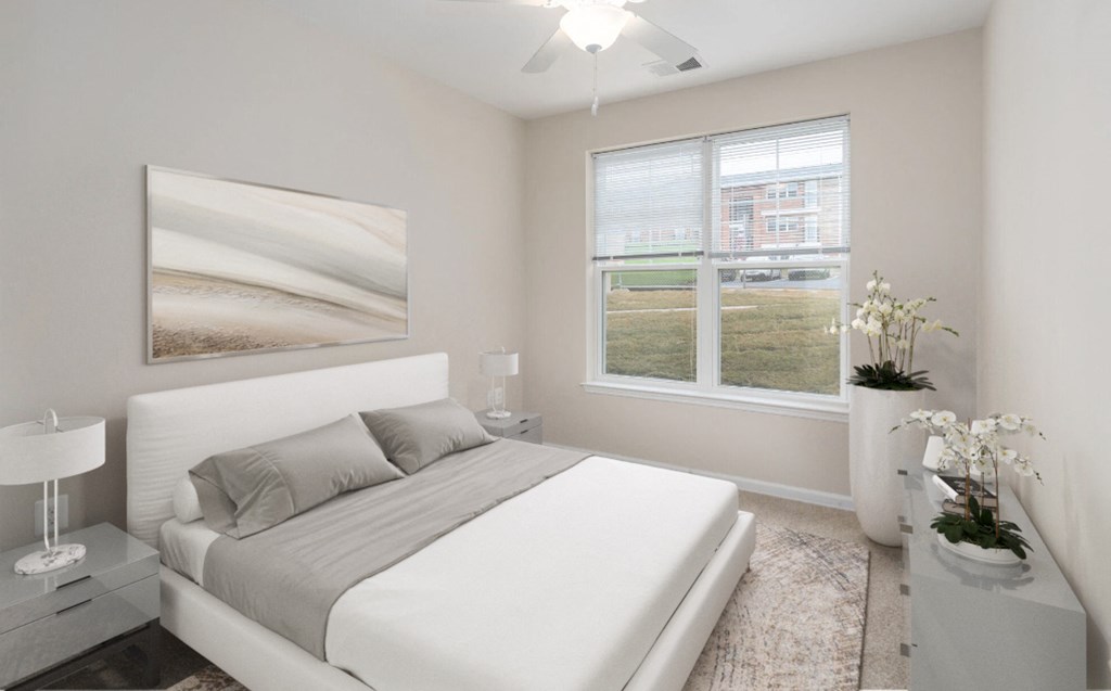 a white bedroom with a white bed and a window