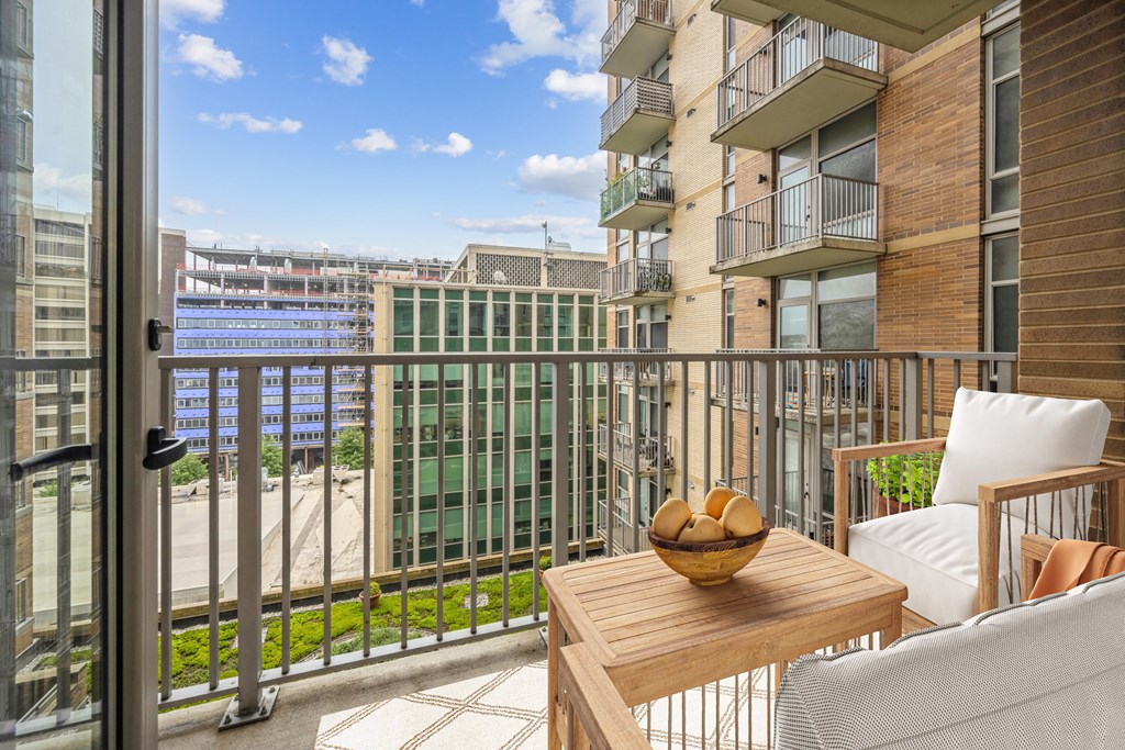 a balcony with a chair and a table