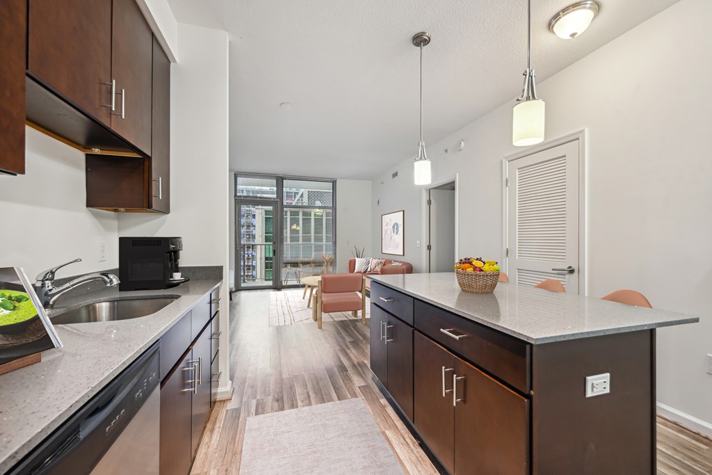 an open kitchen with a large island and a living room with a couch