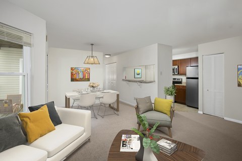 A living room with a white couch and a coffee table.