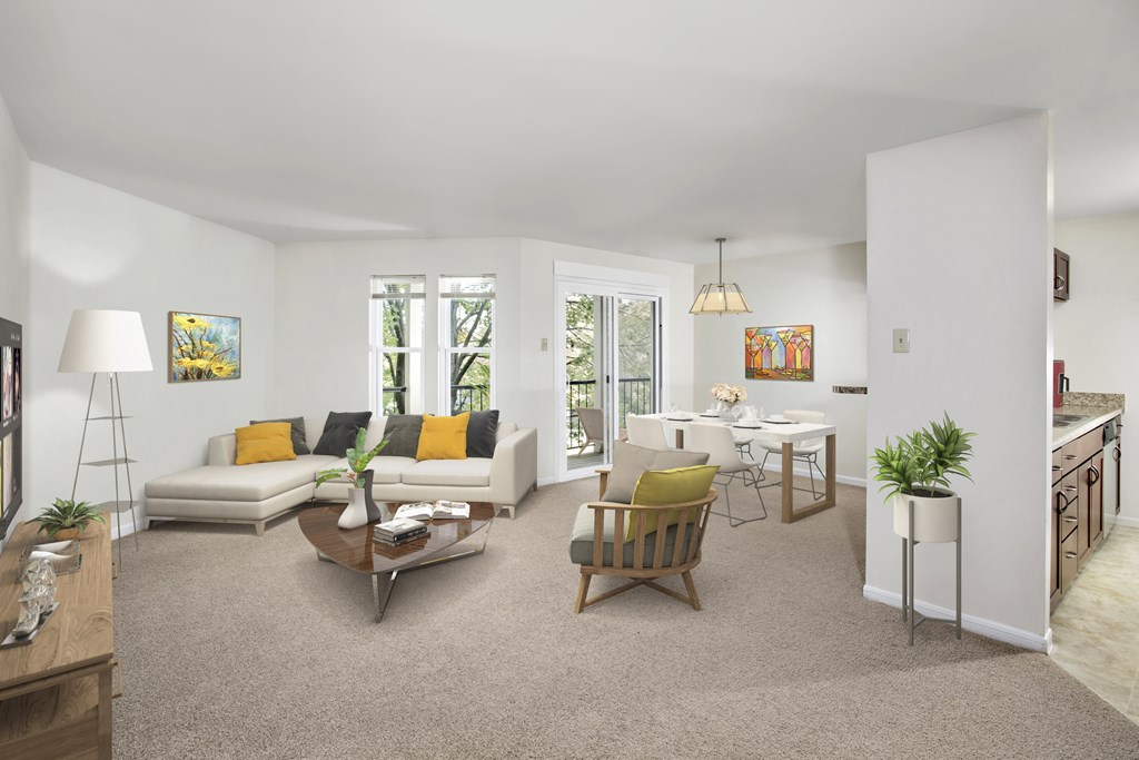 A living room with a white couch and a yellow pillow.