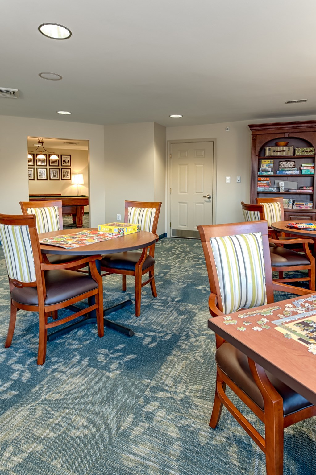 A dining room with a table and chairs.