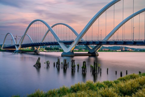 A bridge with a unique design spans across a body of water.