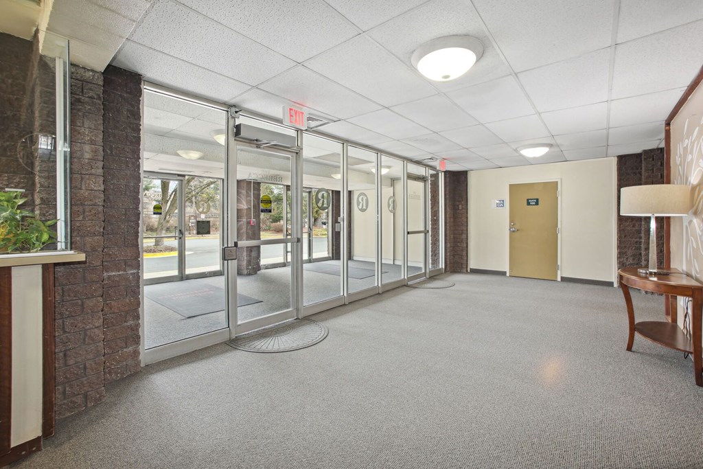 the lobby of an empty office building with glass doors