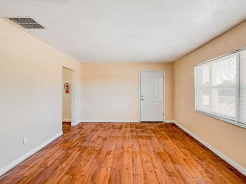 A room with wooden floors and a white door.