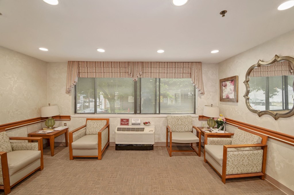 a waiting room at a hospital with chairs and a window