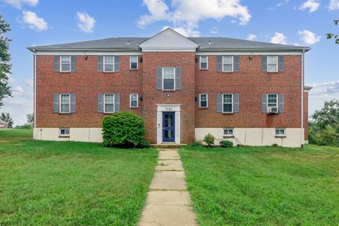 an old brick building with a sidewalk in front of it