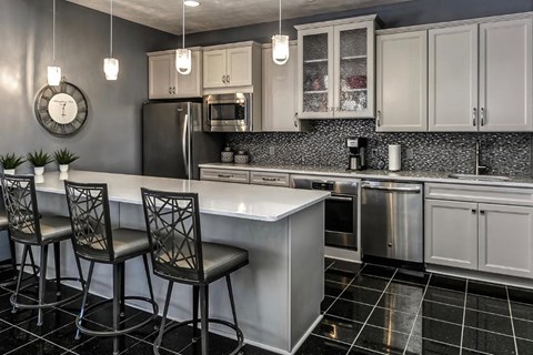 a kitchen with a center island and three chairs