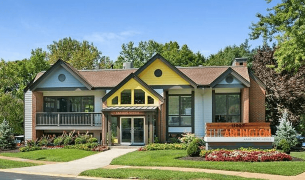 A building with a sign that says "The Arbhington" in front of it.