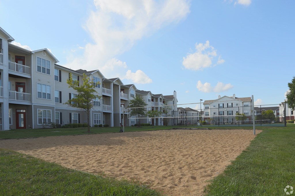 A sandy area in front of apartment buildings.