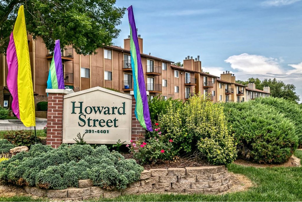 the facade of howard street apartments with colorful flags