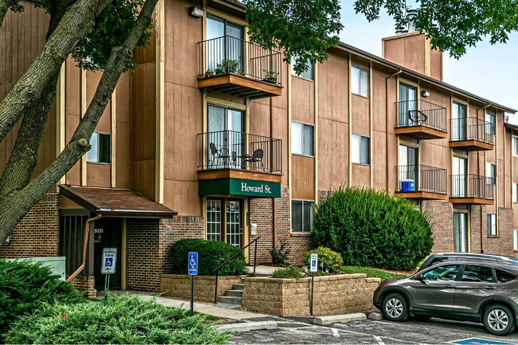 an apartment building with a car parked in front of it