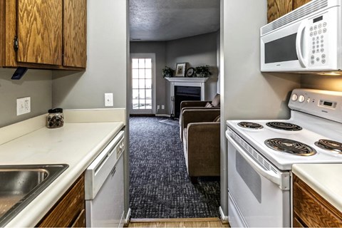 a kitchen with a stove microwave and a sink