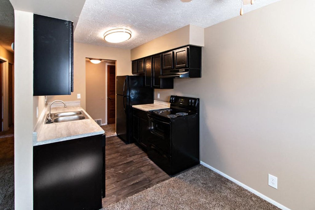 a kitchen with black appliances and a counter top