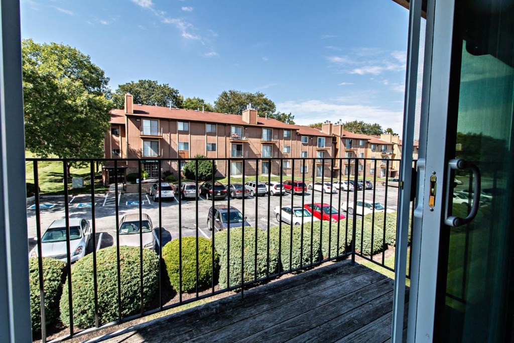 a balcony with a view of a parking lot