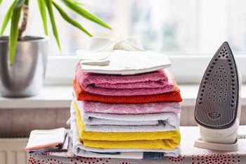a pile of folded towels next to an air dryer