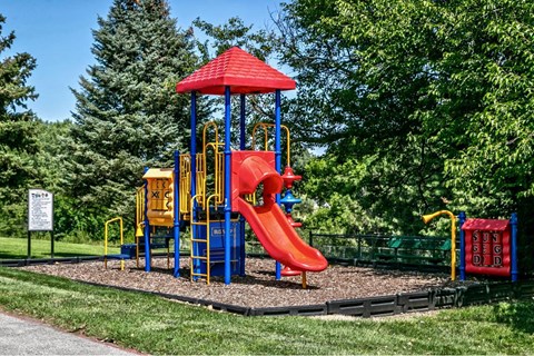 a playground with a swing set and a slide