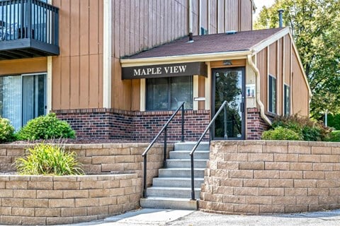 a building with stairs and a sign that reads maple view