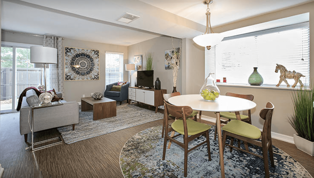 A living room with a white table and chairs.