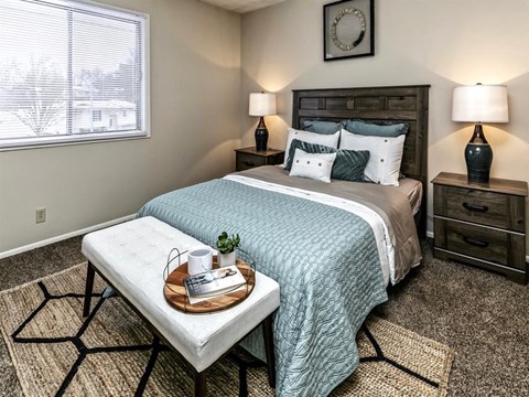 a bedroom with a bed and a table