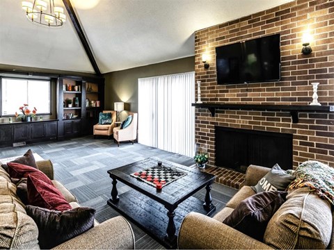 a living room with a couch and a coffee table and a fireplace