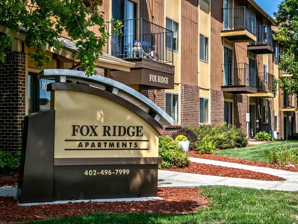 a view of the fox ridge apartments sign in front of the building