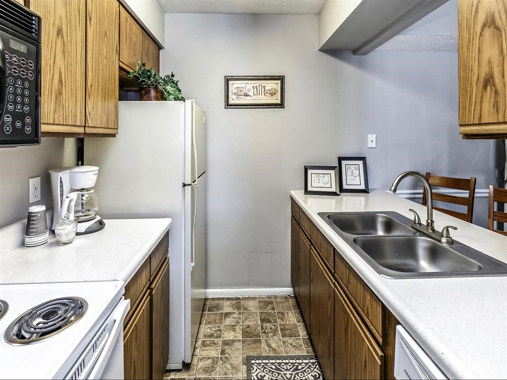 a kitchen with a sink and a refrigerator