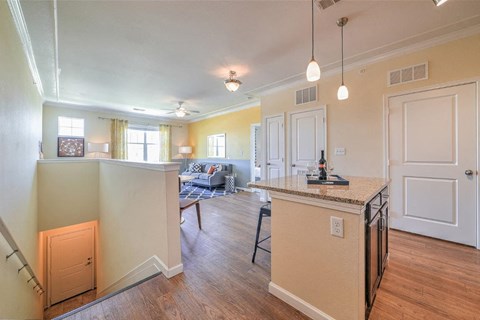 a kitchen with an island and a living room with a couch