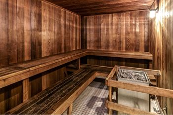 a sauna with wooden benches and a table