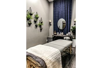 a spa room with a massage table and a mirror