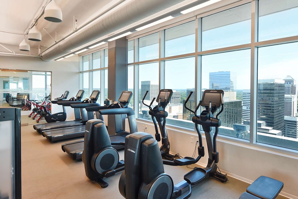 A gym with treadmills and elliptical machines at Two Twelve Clayton Apartments, Clayton, MO