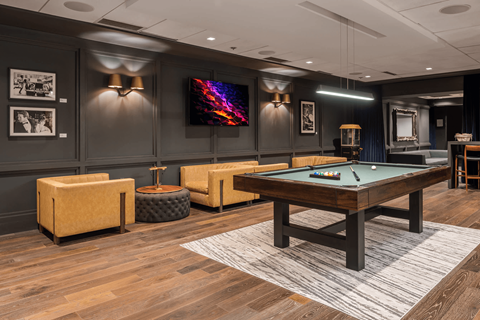A room with a pool table and a television at Clayton on the Park Apartments, Clayton, MO