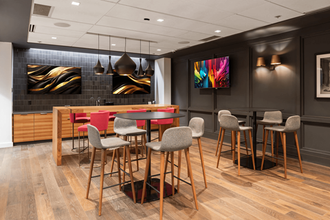 A modern dining room with a wooden table and chairs at Clayton on the Park Apartments, Missouri
